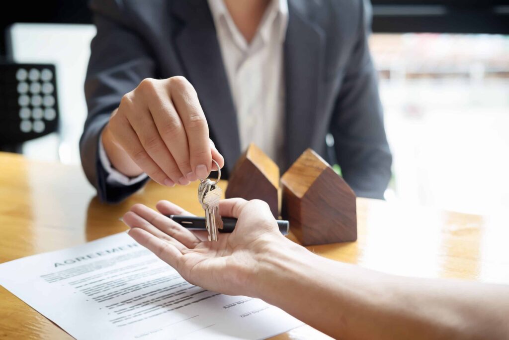 Agent dropping keys in new home owners hands in Boise Idaho.