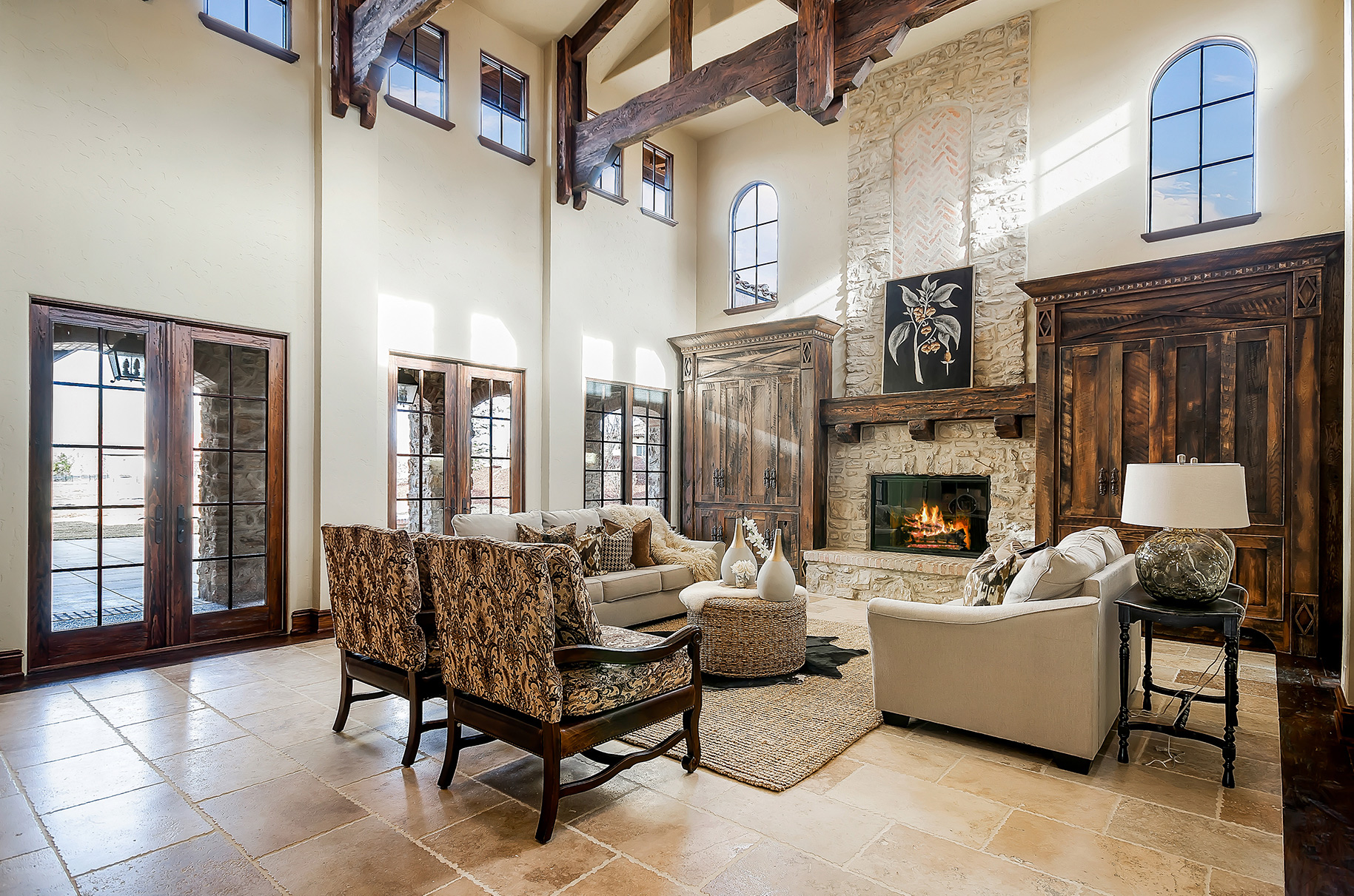 Spacious living room with vaulted ceilings, stone fireplace, and elegant staging showcasing natural light in boise idaho.