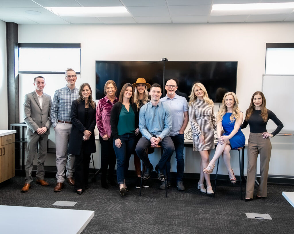 Agents apart of Amherst Madison Real Estate Advisors team smiling for group photo in Boise Idaho.
