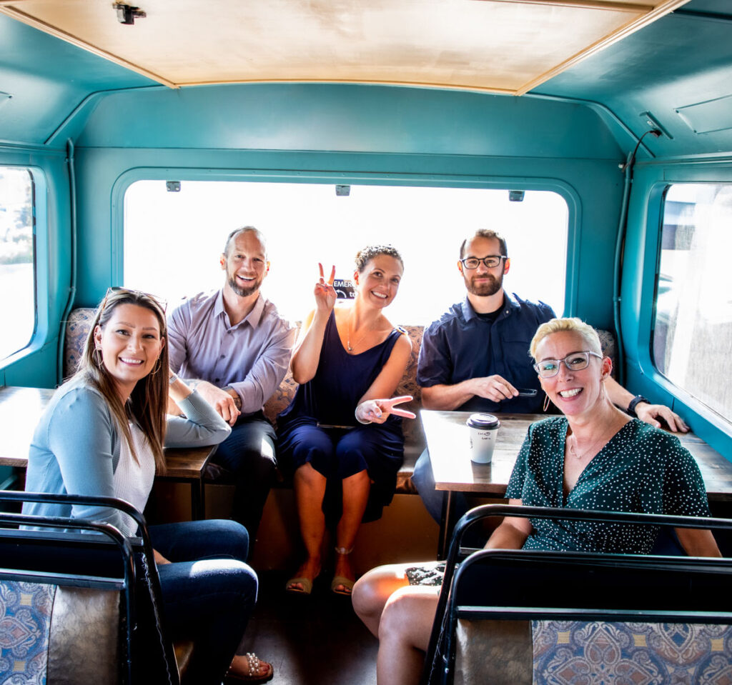 Happy real estate agents enjoying coffee in Boise's own coffee bus.