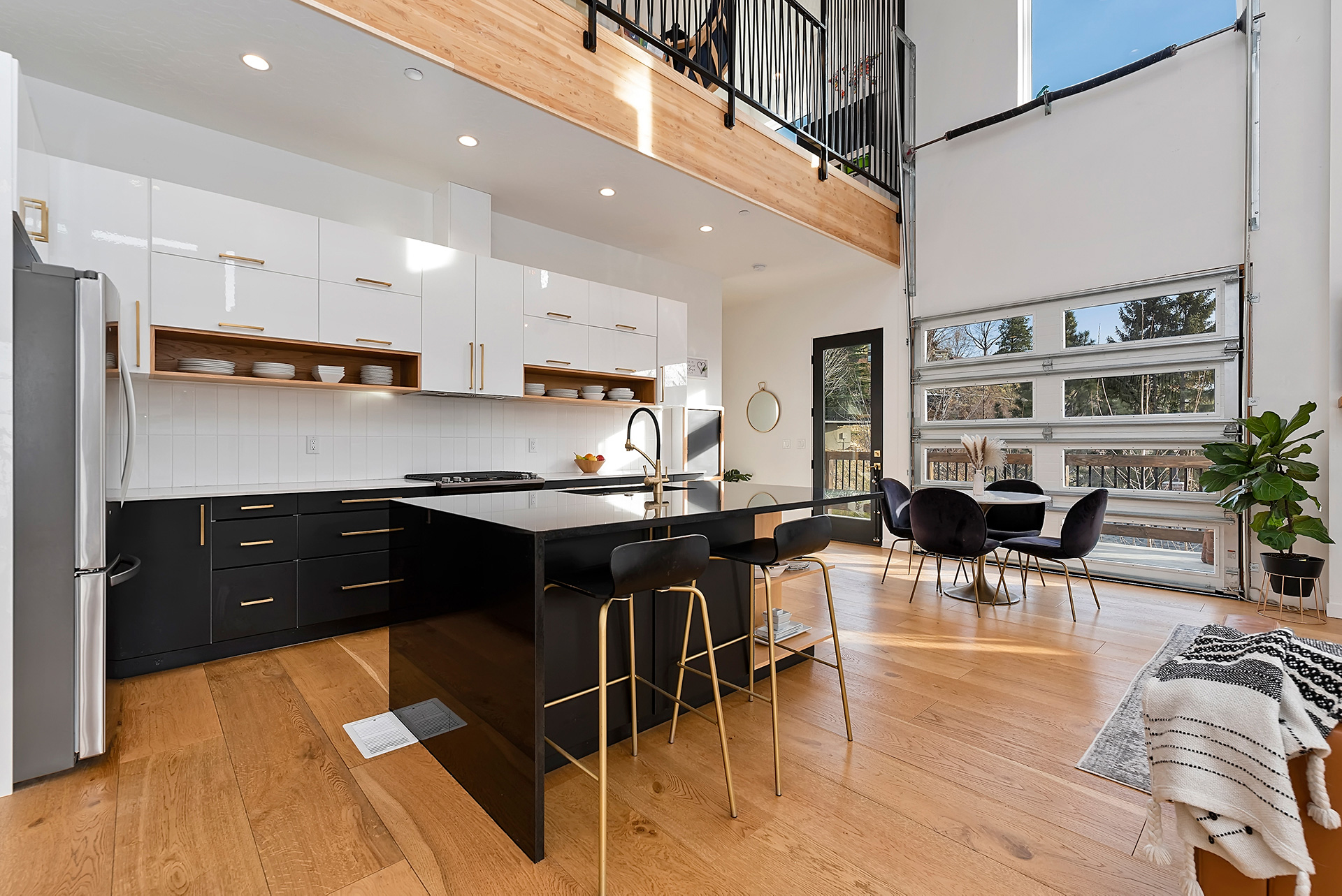 Bright modern kitchen with large island, open floor plan, and natural light highlighting home features in boise idaho.