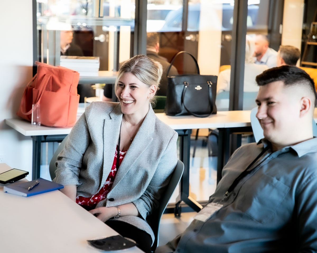 Smiling real estate professionals collaborating during a team meeting in Boise Idaho.