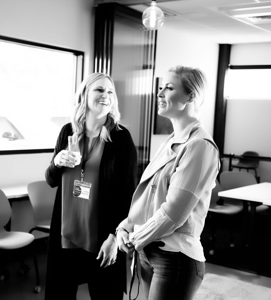 Happy real estate agents smiling and collaborating in Boise Idaho.
