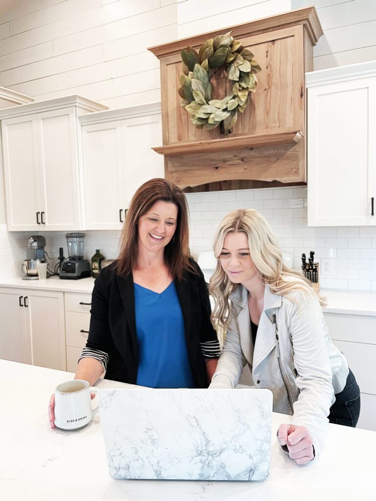 Smiling real estate professionals collaborating during a home showing in Boise Idaho.